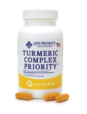 Bottle of turmeric complex dietary supplement with capsules